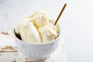 homemade vanilla ice cream in a white bowl